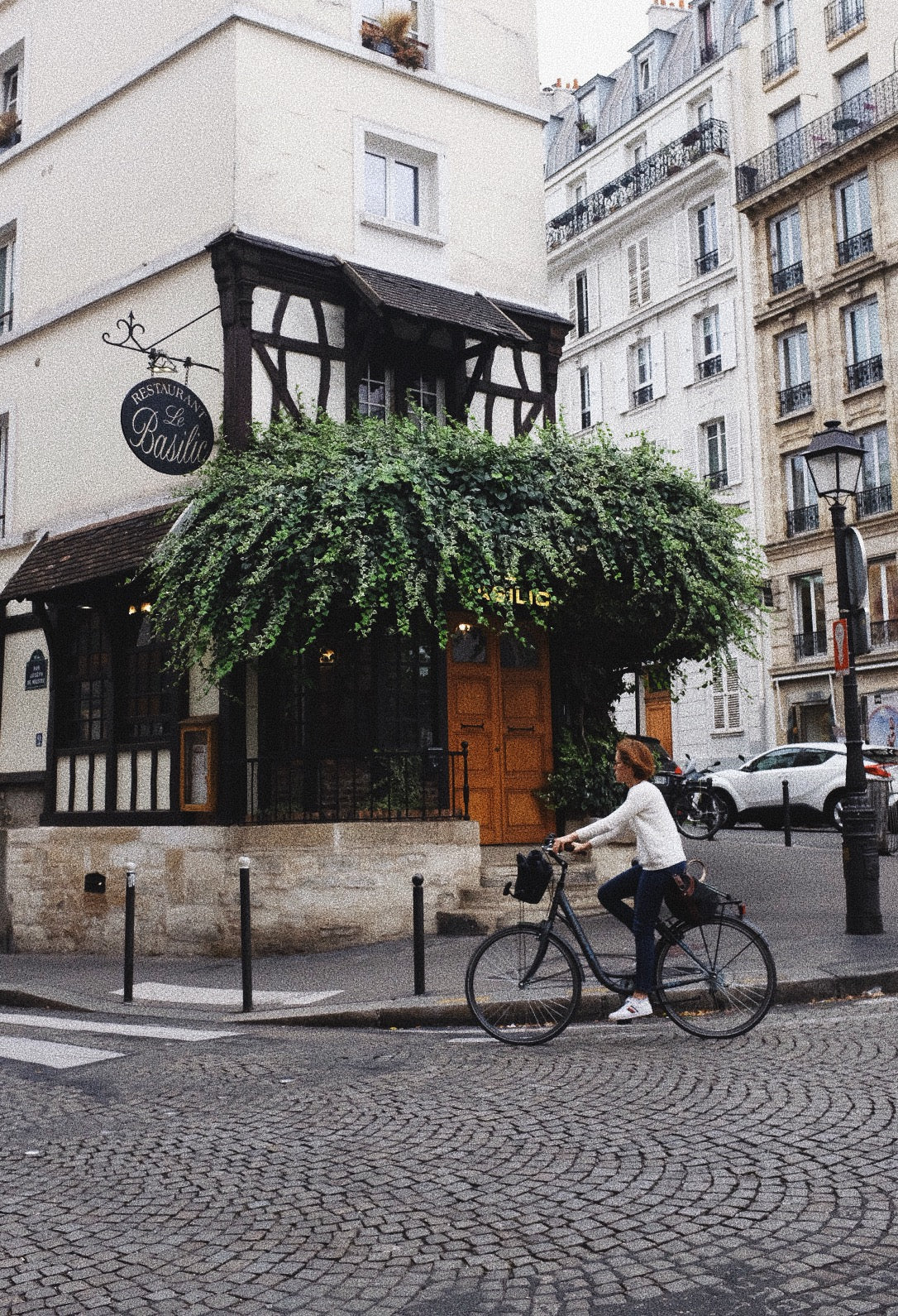 Woman riding bicycle through Paris