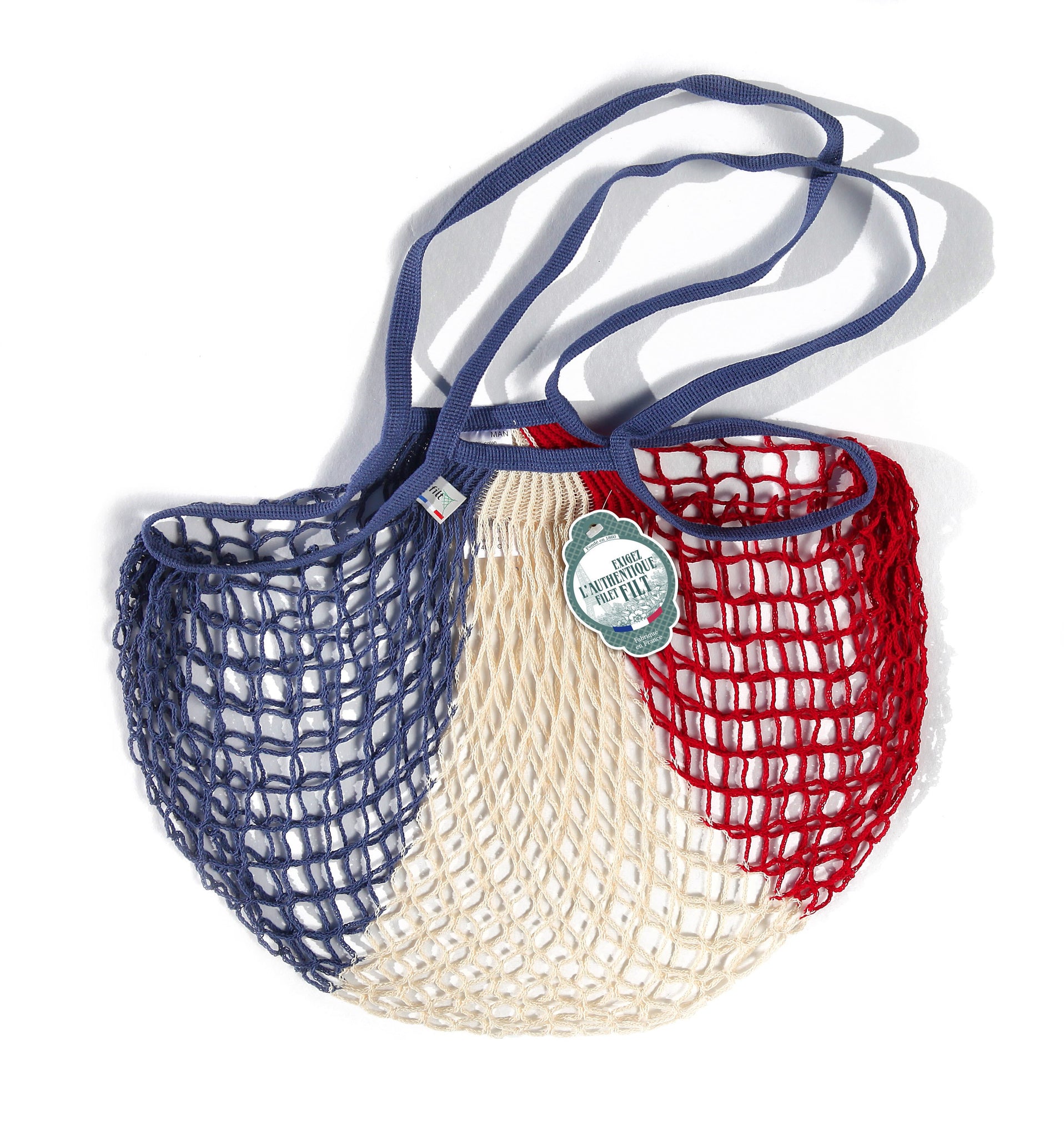 Red white and blue netted tote bag with hang tag reading Exigez l'authentique filet filt. Fabrique en France.