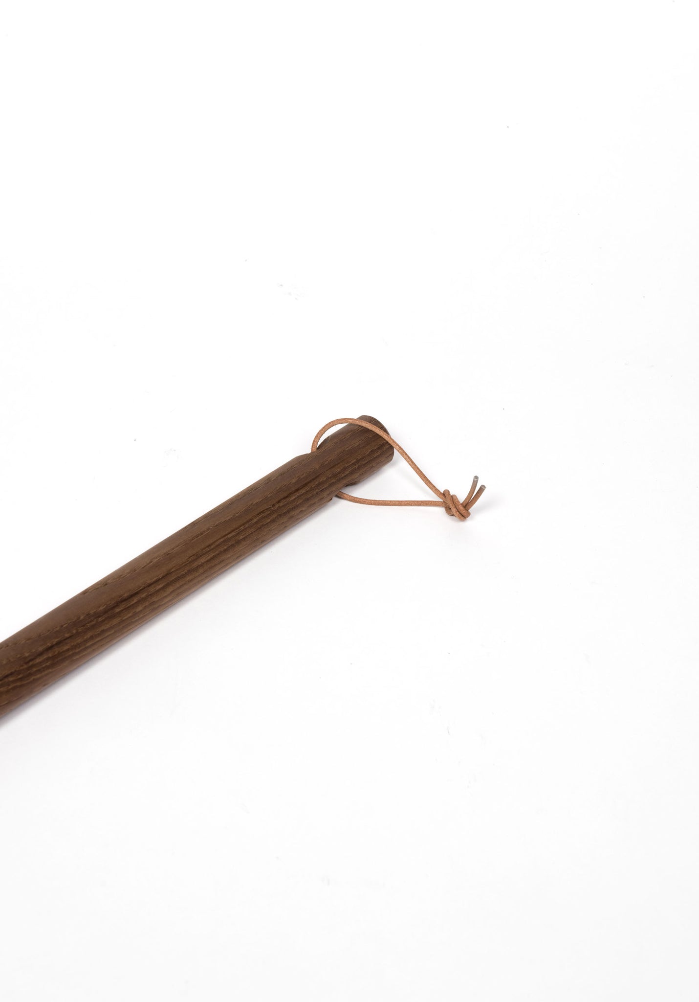 Wooden broom handle with leather loop for hanging.