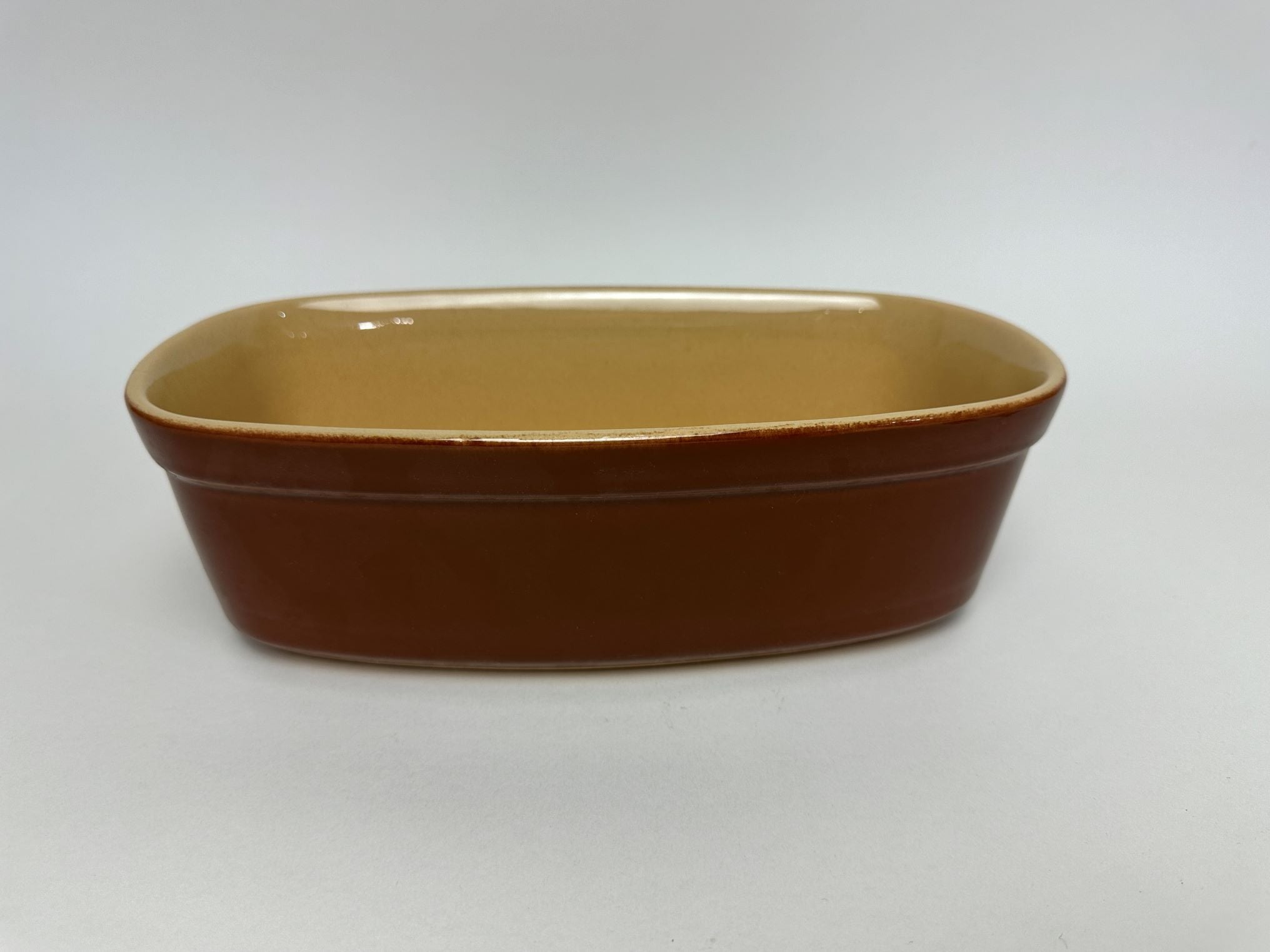 Rectangular Vintage French terrine baking dish in brown ceramic with a cream color interior.