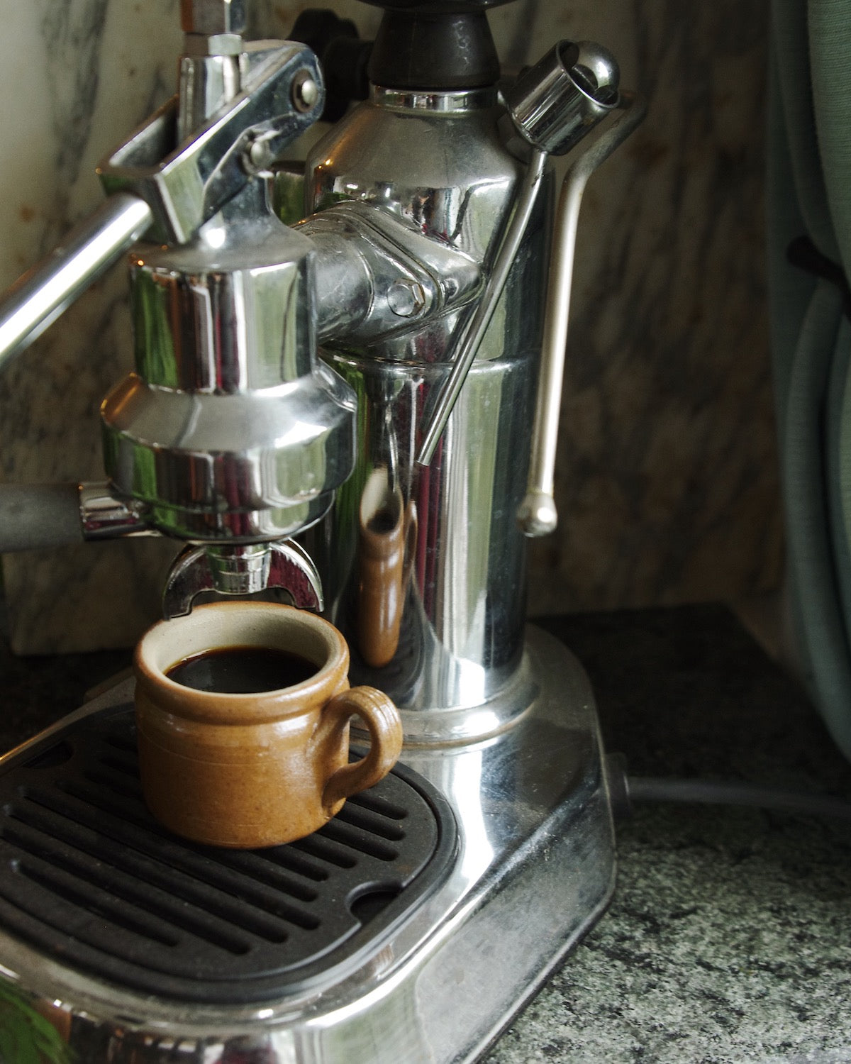 Brown mug in espresso machine.
