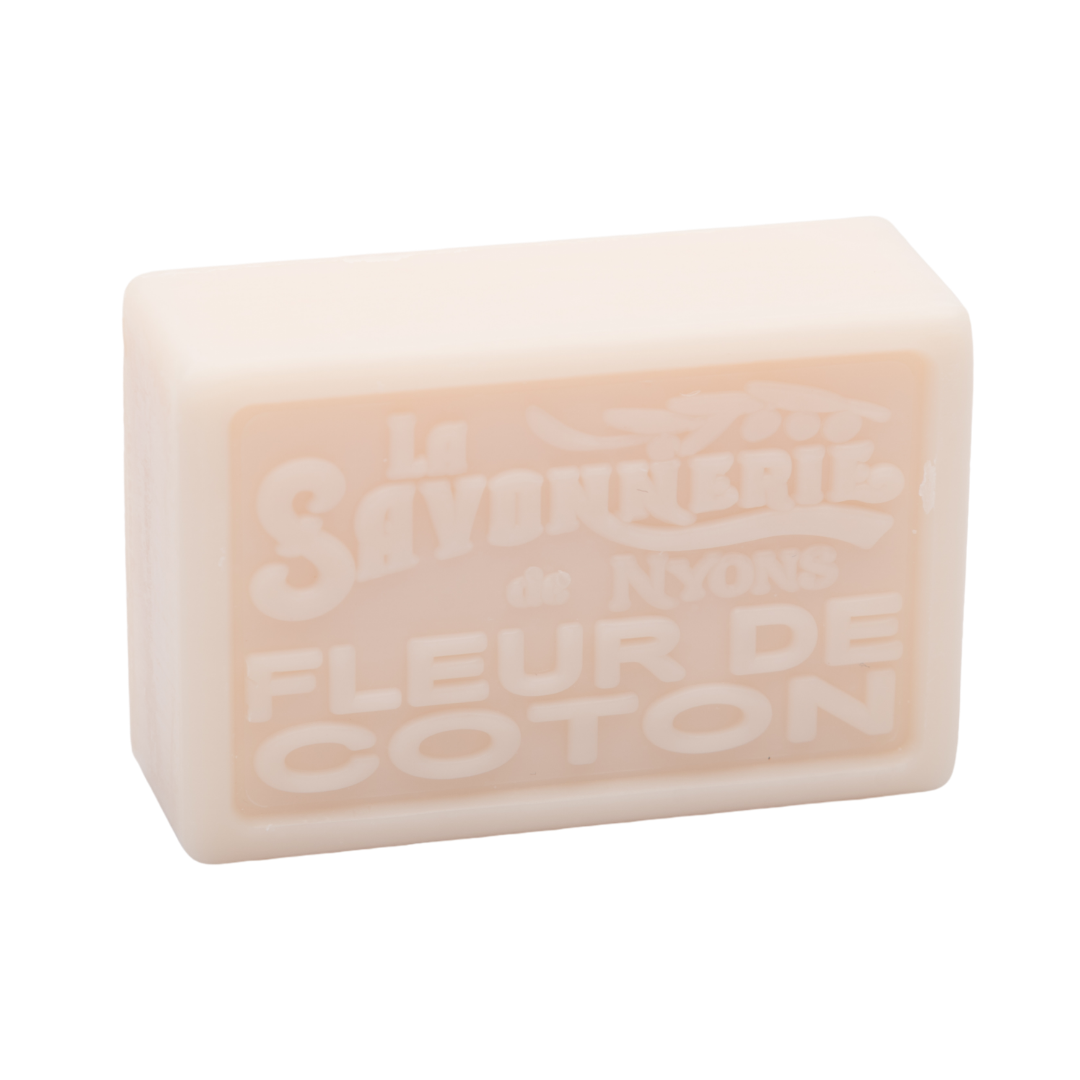 Cream colored bar of soap reading La Savonnerie de Nyons Fleur de Coton.