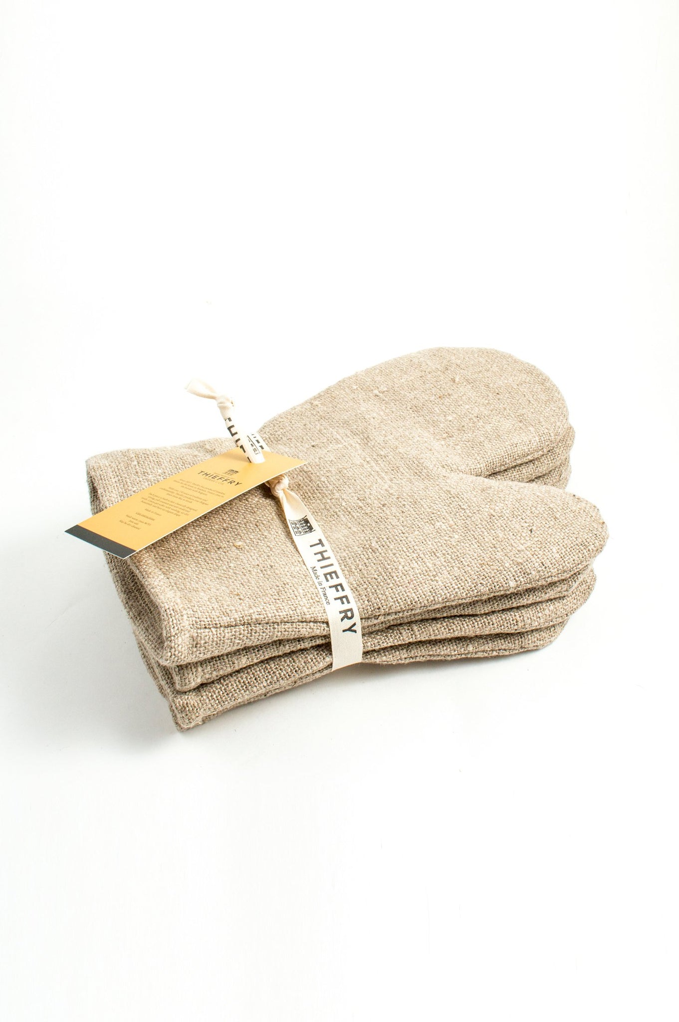 Stack of linen oven mitts wrapped in ribbon that rieds Thieffry Made in France.