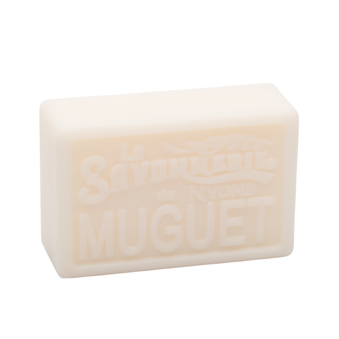 Pale yellow bar of soap that reads La Savonnerie de Nyons Muguet.