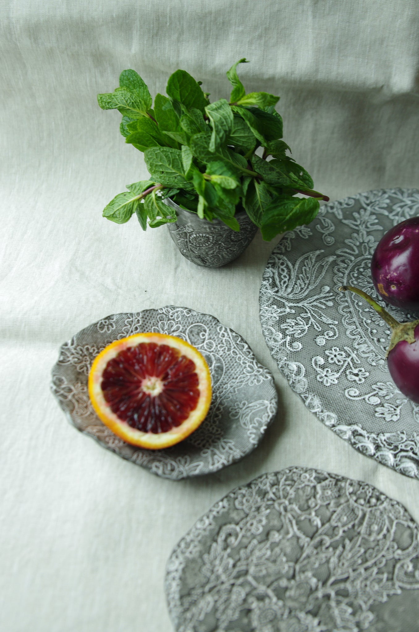 Lace pattern ceramic tableware serving fruits and herbs